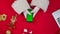 Top view Santa hands uses smartphone with green screen chroma key by red New Year decorated table. Santa Claus tapping