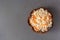 Top view of sauerkraut and carrot wooden bowl on neutral background.