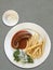 top view Sausage and boiled Vegetable with Cream Sauce and French fries on a white ceramic plate,grey floor background