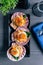 Top view of scallop in shell with spicy pomelo salad served in black plate