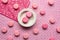 top view of scattered macarons on a pink tablecloth