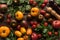 Top view of scattered tomatoes and spinach near pepper mill and salt mill on wooden table.