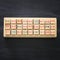 Top view of school multiplication, subtraction and connection exercises over wooden blocks game.