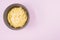 Top view of scrambled omelette on a bowl isolated on light purple background