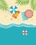 Top view seascape, beach umbrellas, inflatable balls, shells and tropical leaves on the sandy shore. Travel concept.