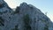 Top view of seascape with rocky coast. Shot. Rocky coast with shady side on background of blue sea and horizon with sky