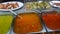 Top view of selection of various platters with delicious asian food and spices on a street market stall in Bangkok