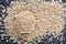 Top view selective focus picture of pile of oatmeal on dark background.