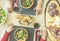 Top view of senior friends eating salad ,salami,cheese and italian ham - Old people toasting red wine for dinner at restaurant -