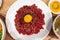 Top view of served beef tartare with fresh yolk