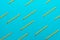 Top view of sharpened simple yellow pencils over turquoise blue background