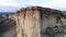 Top view of sheer cliff. Shot. Amazing panoramic view of steep white rock with erosion at its foot. White mountain with