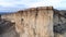 Top view of sheer cliff. Shot. Amazing panoramic view of steep white rock with erosion at its foot. White mountain with