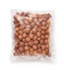 Top view of shelled hazelnuts in transparent plastic bag