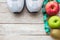 Top view shoe,measuring tape and apple on wood table background