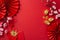 Top-view shot featuring fans, Feng Shui trinkets, traditional coins, sycee, envelopes, dragon charm wall hanging on red backdrop