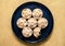 Top view shot of mince pies served on a dish on a beige background