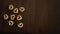 Top view shot of a pile of some tiny heart-shaped cereals on a wooden table