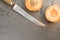 Top view shot of sliced plums and a knife on a smooth surface