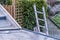 Top view of a silver aluminum ladder leaning against the wall of the house