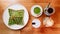 Top view of Singapore green pandan crispy waffle, green tea latte, heart latte and coffee served in white plate on wooden table