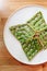 Top view of Singapore green pandan crispy waffle served in white plate on wooden table