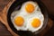 Top view of sizzling fried egg and crispy bacon in a pan, creating a delicious breakfast dish