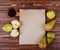 Top view of a sketchbook and fresh ripe pears with a glass of pear juice on wooden background