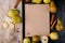 top view of sketchbook made of craft paper framed with fresh ripe pears and a wooden chopping board with kitchen knife and slices