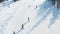 Top view of skiers and snowboarders riding on mountain. Footage. Ski resort with active rest on skis and snowboard in