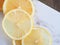 Top view slice lemon fruit on marble cutting board.