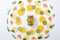 Top view of sliced kiwi, oranges, lemons, grapefruits, mint, rosemary and detox drink in jar on grey background.