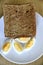 Top view of slices of toasted whole wheat bread with boiled eggs on a plate for breakfast