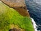 Top view of slimy green algae on the rocks in the coast