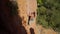 top view slow motion of strong man rock climber climbs on limestone cliff by tough route. athletic climber makes hard