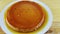 Top view slowly panorama at whole round soft milk flan with caramel syrup