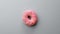 Top view slowly rotating appetizing fresh ring donut with pink icing isolated. 4k Dragon RED camera