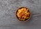 Top view of a small bowl of Mexican rice and beans on a gray background