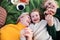 Top view of small girl with mother and grandmother having picnic in nature.