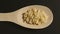 TOP VIEW: Small letter pasta appears in wooden spoon