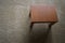 Top view of small teak table on beige carpet.