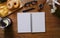 Top view smart phone, coffee cup, glasses, stationery and donuts on wooden table. Flay lat