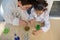 Top view of smart school kids conducting fascinating chemical experiment, using regents, chemicals and glass labware