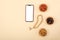 Top view of smartphone with white screen, rosary lying next to dried fruits, religious concept, love of Islam, copy space, mock up