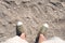 Top view of sneaker shoe stand on sand at sea beach in sunny day,summer vacation holiday lifestyle.Leave space on top for adding