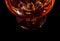 Top of view of snifter of brandy in elegant typical cognac glass on black background