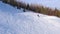 Top view of a snowboarder sliding down from the top of a mountain on a winter sunny day. The concept of snowboarding.