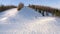 Top view of a snowboarder sliding down from the top of a mountain on a winter sunny day. The concept of snowboarding.