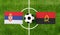 Top view soccer ball with Serbia vs. Angola flags match on green football field