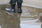 Top view a soldier wearing black boots standing in a puddle